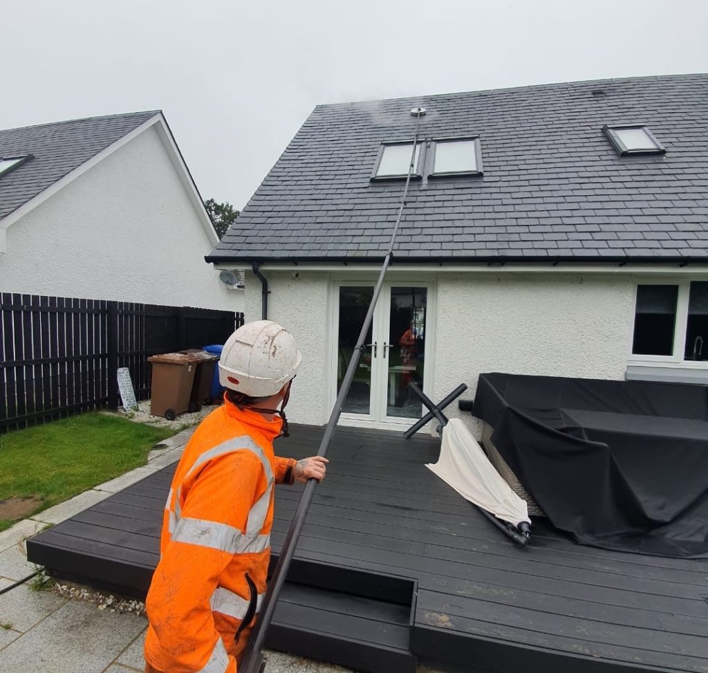 Steam cleaning a residential roof on a Christchurch Rd, Ringwood town, Hampshire